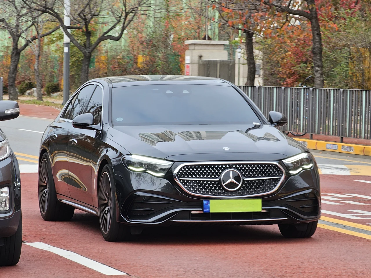 Black Mercedes-Benz E-Class W214 sedan, full front three-quarter view